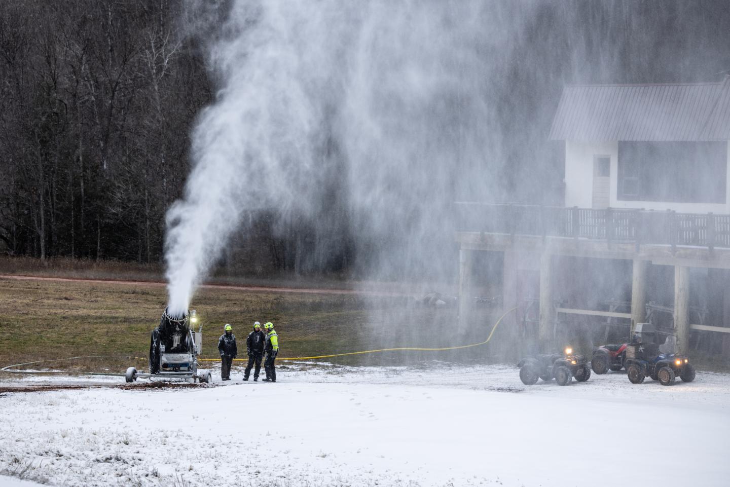 Snowmakers inspect a snowmaking gun at the bottom of Black River Basin.